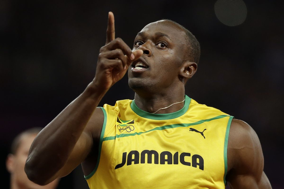 Jamaica's Usain Bolt holds up one finger after finishing first in the men's 100. (Associated Press)