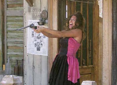 
An unidentified dance hall girl draws down on an outlaw as members of the cast of The Virginia City Outlaws shoot it out three times daily in a streetside theater in Virginia City, Nev.
 (Associated Press / The Spokesman-Review)