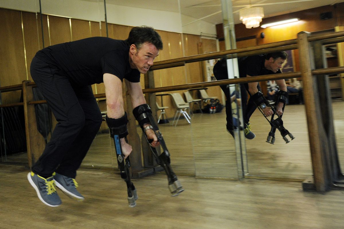 Terry Notary demonstrates how he achieved apelike movements with arm extenders for his motion capture performance for “Dawn of the Planet of the Apes.” (Associated Press)