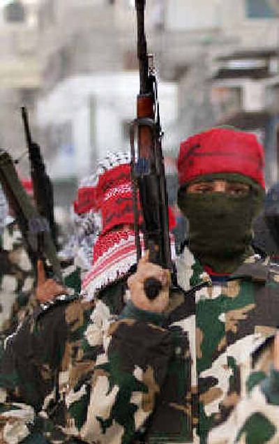 Masked gunmen of the Popular Front for the Liberation of Palestine march during an anti-Israel rally on Sunday.
(Associated Press / The Spokesman-Review)