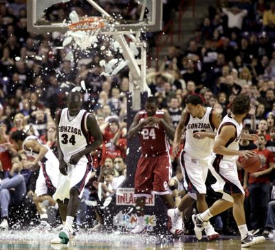 Gonzaga's Bol Kong (34) gets out of the way after a dunk by Oklahoma's Tiny Gallon (24) shattered the backboard during the second half of an NCAA college basketball game in Spokane, Wash., Thursday, Dec. 31, 2009. (Rajah Bose / Fr120940 Ap)