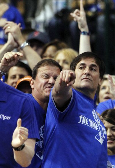 Mavericks owner Mark Cuban, right, watches from the sidelines as Dallas won to take a commanding 3-0 series lead over the Lakers. (Associated Press)