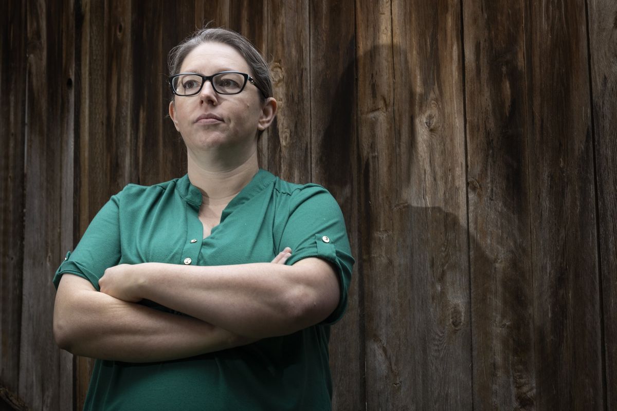 Pamela Hayter, a former Amazon employee, stands in the backyard of her Kirkland, Wash., home Monday. Hayter was one of the most vocal critics of the company’s return to office mandate.  (Ellen M. Banner/Seattle Times)