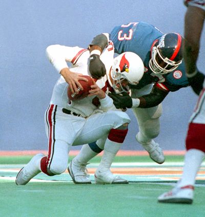Giants linebacker Harry Carson sacks Cardinals quarterback Neil Lomax in a 1986 game. Carson is suffering from the effects of a dozen or more concussions. (Associated Press)