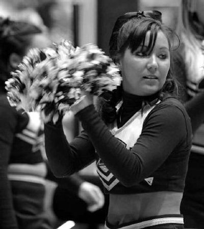 
Cheerleader Kristi Yamaoka cheers on the sidelines just prior to the start of a game last month. 
 (Associated Press / The Spokesman-Review)