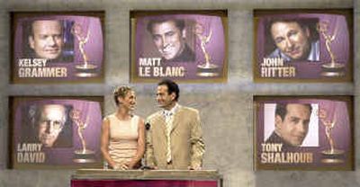 
Emmy nominations co-host Tony Shalhoub smiles at Edie Falco, who stars in HBO's ‘The Sopranos,' when she announced Shalhoub's nomination for best lead actor in a comedy series for his role in ‘Monk' during the nominations ceremony Thursday in Los Angeles. Falco was also nominated for best lead actress in a drama series 
 (Associated Press / The Spokesman-Review)