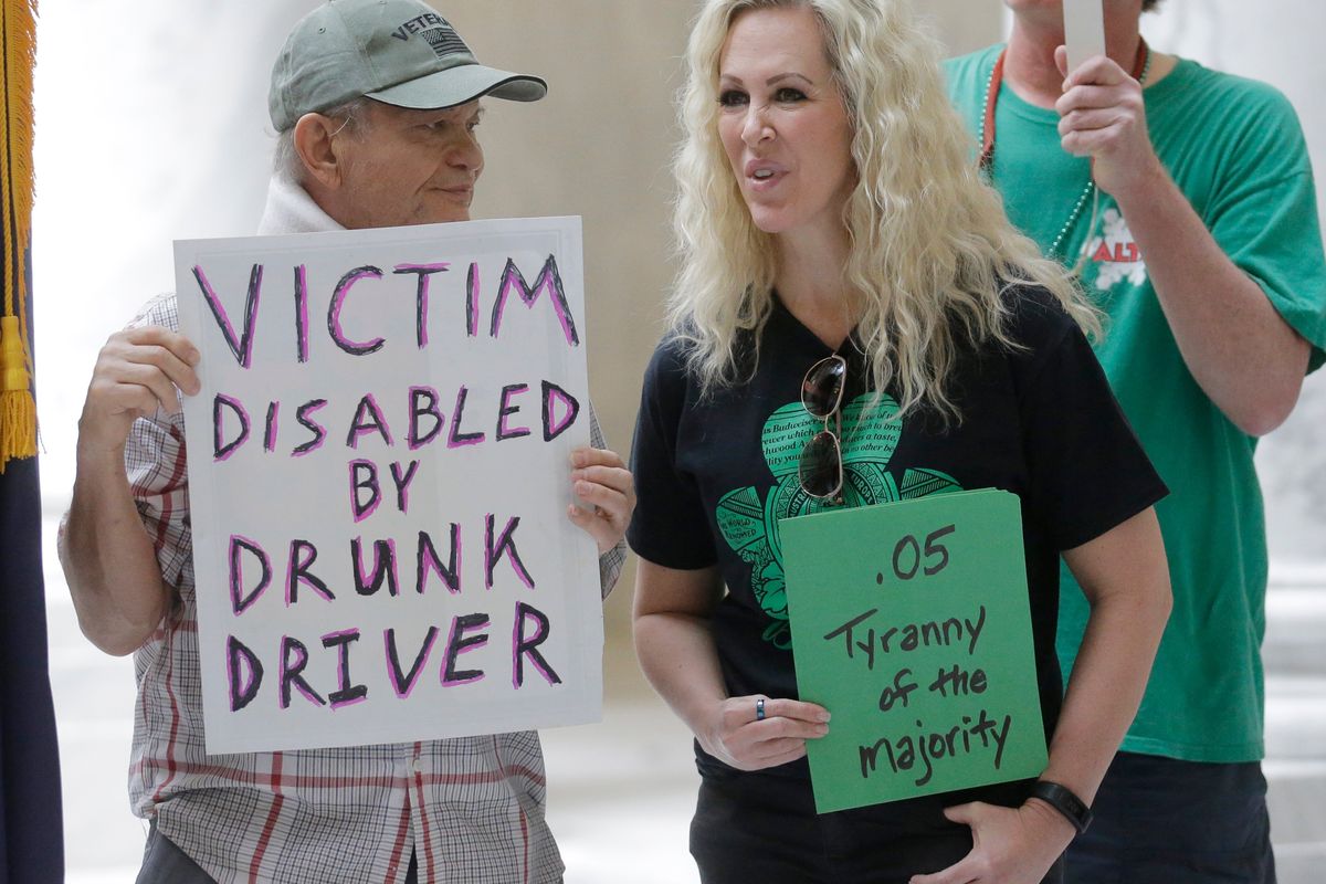FILE — In this March 17, 2017, file photo, Ed Staley, left, and Tali Bruce, right, attend a rally concerning the DUI threshold at the Utah state Capitol in Salt Lake City. Car crashes and traffic deaths decreased in Utah the after state enacted the strictest drunken driving laws in the nation. A study published, Friday, Feb. 11, 2022, by the National Highway Traffic Safety Administration suggests Utah's roads became safer after the state lower the drunken driving threshold to .05% blood-alcohol content.  (Rick Bowmer)