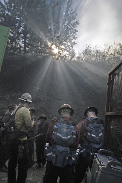 South of Spokane: Firefighters from the Department of Natural Resources and Spokane County Fire District 10 plan their attack before hiking up a hill through a haze of smoke along Highway 195 just south of Spokane where two small fires were reported Wednesday about 3:30 p.m. Crews from multiple agencies responded, including Spokane County Fire District 3, the Bureau of Land Management and Turnbull Wildlife Refuge. Officials believe the fires may have been caused by hot carbon coming from a semitruck pulling a heavy load up the hill. No injuries were reported in the fires, which burned 1.3 and 1.6 acres. (Christopher Anderson)