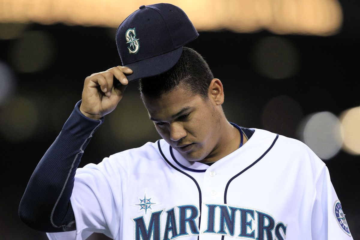 M’s starting pitcher Felix Hernandez tips his cap to fans as he leaves the game in the seventh inning.  (Associated Press)