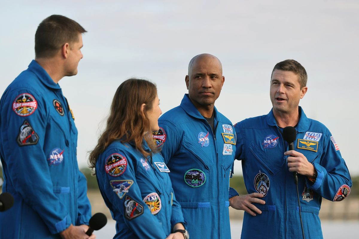 Artemis II crew members Jeremy Hansen, left, mission specialist, the Canadian Space Agency; Christina Koch, mission specialist, NASA; Victor Glover, pilot, NASA; and Reid Wiseman, spacecraft commander, NASA; talk to the media, as the Artemis II rocket rolls out to Launch Complex 39-B at the Kennedy Space Center on Jan. 17 in Cape Canaveral, Fla. (Orlando Sentinel)