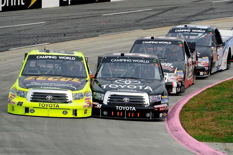 Denny Hamlin, driver of the #51 Toyota Toyota, passes Matt Crafton, driver of the #88 Zecol/Menards Toyota, for the leads during the NASCAR Camping World Truck Series Kroger 200 at Martinsville Speedway on October 27, 2012 in Ridgeway, Virginia. (Photo Credit: John Harrelson/Getty Images for NASCAR) (John Harrelson / Getty Images North America)