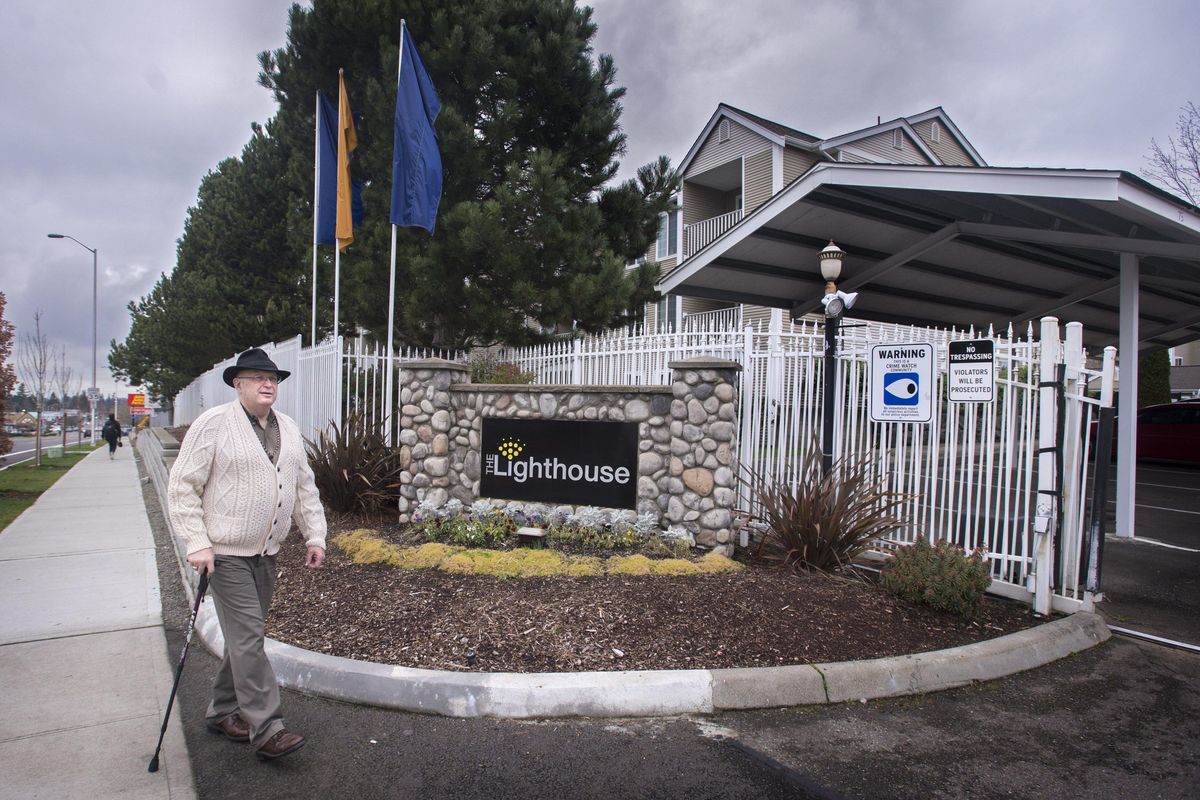 John Hannaman walks pass the security gate at the Lighthouse Apartments on his way back to his apartment in Kent, Wash. (Lui Kit Wong)