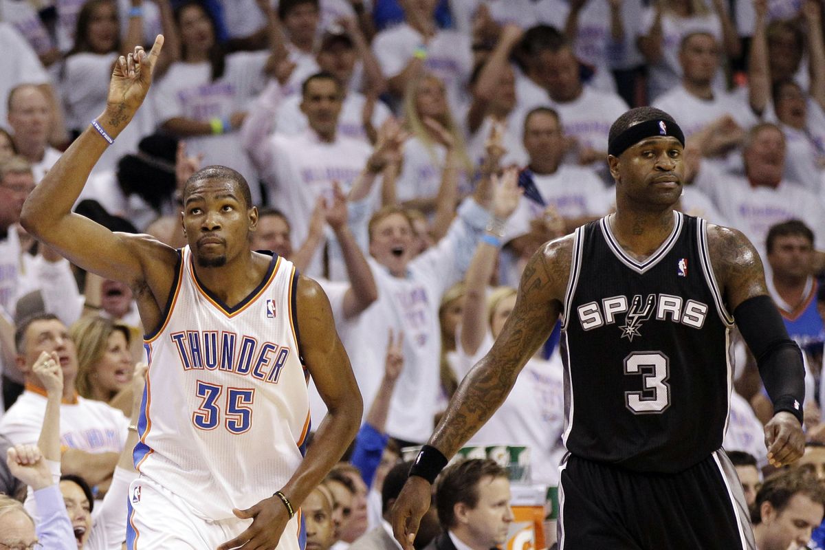 Thunder forward Kevin Durant, who had a double-double, gestures as he runs by San Antonio Spurs shooting guard Stephen Jackson during the first half of Game 6. (Associated Press)