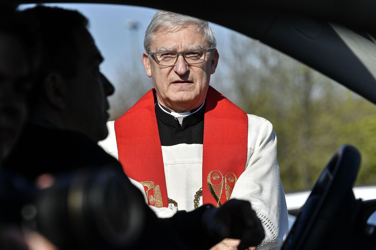 Priest Frank Heidkamp talks to believers in their cars prior a Good Friday church service at a drive-in cinema when all German churches are closed for worships due to the coronavirus outbreak in Duesseldorf, Germany, Friday, April 10, 2020. (Martin Meissner / associated press)