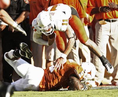 Texas linebacker Sergio Kindle knocks Oklahoma State quarterback Zac Robinson for a 3-yard loss.  (Associated Press / The Spokesman-Review)