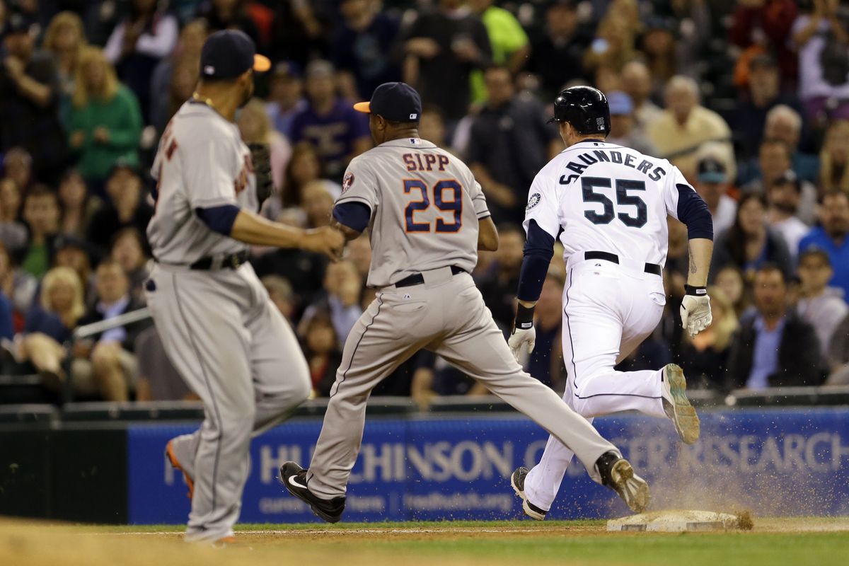 Michael Saunders is safe at first base with a seventh-inning two-run single just ahead of Astros RP Tony Sipp’s force attempt. (Associated Press)