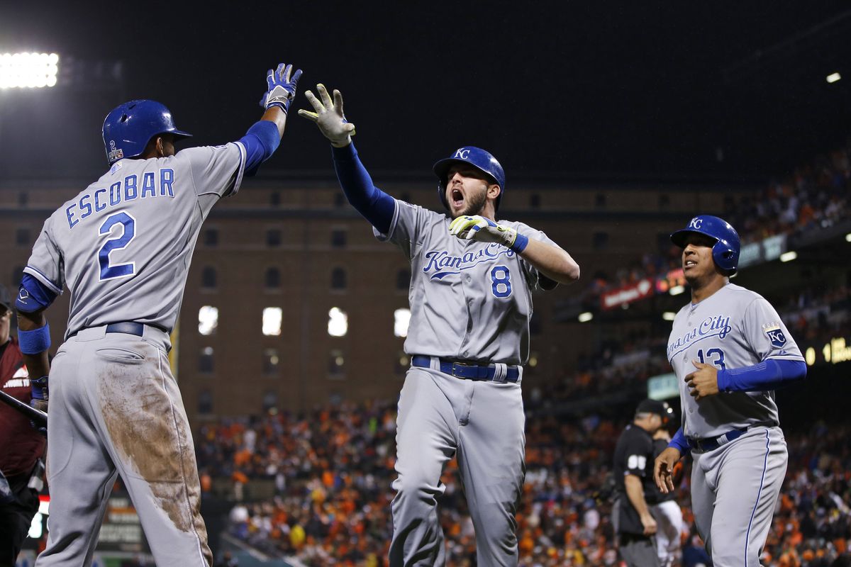 Royals’ Mike Moustakas, center, celebrates with Alcides Escobar, left, after Moustakas hit a two-run home run in the 10th inning. (Associated Press)