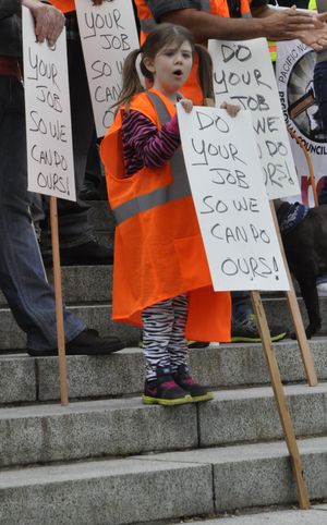 OLYMPIA -- Ava Conner, age 6, joins a rally on the Capitol steps in support of new package of transportation projects and taxes. (Jim Camden)