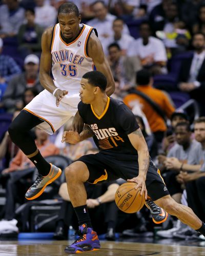 The Suns’ Gerald Green drives on the Thunder’s Kevin Durant. Green finished with 41 points in Phoenix’s comeback win. (Associated Press)