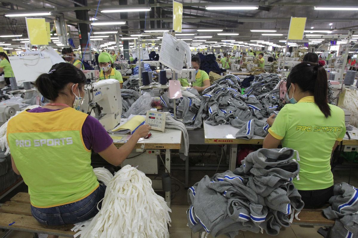 In this Oct. 24, 2017, photo, garment workers sew clothes at Pro Sports factory in Nam Dinh province, Vietnam. U.S. President Donald Trump’s decision to withdraw from a far-reaching Pacific Rim trade pact is having scant impact on fast-growing trade in the region. (Tran Van Minh / AP)