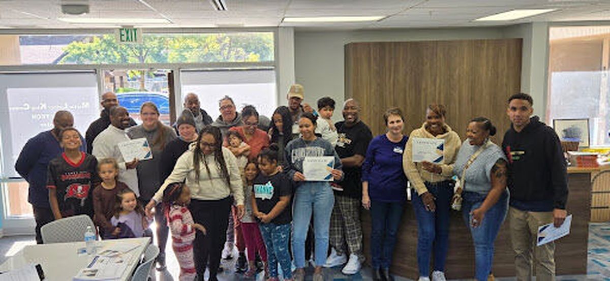 Chauncey Jones, fifth from the right holding a baby, is a community and wealth builder.  (Courtesy)