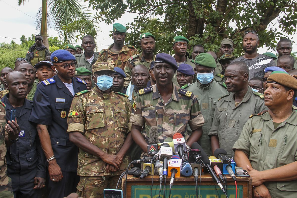 Colonel-Major Ismael Wague, centre, spokesman for the soldiers identifying themselves as National Committee for the Salvation of the People, speaks during a press conference at Camp Soudiata in Kati, Mali, Wednesday, Aug. 19, 2020, one day after President Ibrahim Boubacar Keita was forced to resign in a military coup. The military takeover was swiftly condemned by the international community, despite promesses of new elections.  (Associated Press)