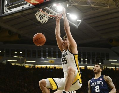 Iowa’s Luka Garza (55) dunks the ball as Penn State’s Myles Dread (2) looks on during the second half of an NCAA college basketball game on Feb. 29, 2020, in Iowa City, Iowa.  (Associated Press)