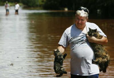 
Marlon Raidt rescues two cats from floodwaters Sunday in Kingfisher, Okla.Associated Press
 (Associated Press / The Spokesman-Review)