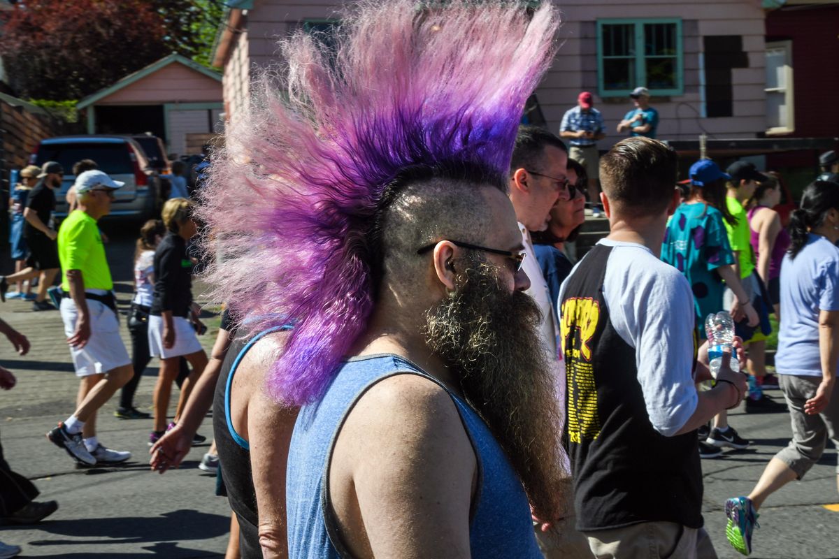 Hair was in full bloom for a Bloomie, Justin Sullivan, walking along Riverside Avenue during Bloomsday 2018, May 6, in Spokane. (Dan Pelle / The Spokesman-Review)
