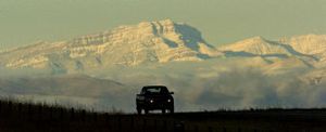 
The early morning sun hits fresh snow on Steamboat Mountain in the Rocky Mountain Front Range as a pickup travels south on Interstate 15 near Ulm, Mont., on Wednesday. A storm dumped large amounts of heavy, wet snow across parts of Montana on Tuesday evening. 
 (Associated Press / The Spokesman-Review)