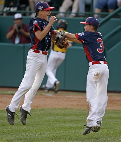 New York’s Michael Mancini, left,, celebrates with teammate Jude Abbadessa after getting the final out of the U.S. championship. (Gene J. Puskar / Associated Press)