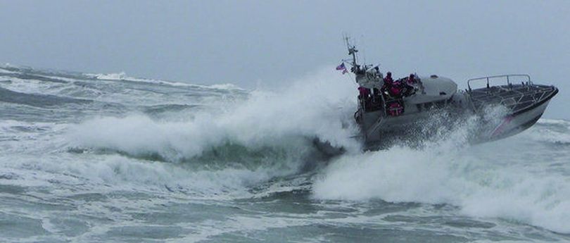 A U.S. Coast Guard 47-foot surf rescue boat challenges the Columbia River bar in conditions much like those June 20, when a fishing boat capsized, killing one man. Five others were rescued. (U.S. Coast Guard)