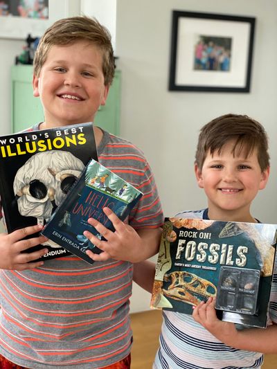 Emmett and Hyrum Ditto show off some of the books they got at their school book fair thanks to a benevolent stranger.  (Courtesy of Julia Ditto)