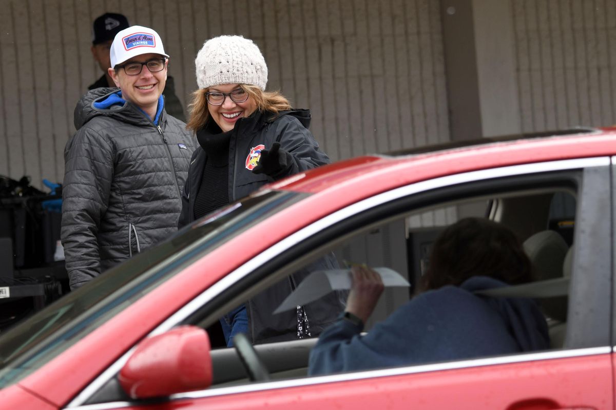 History teacher Jeff Lake, left and Principal Libbi Barrett share smiles as they distribute Chromebooks at Coeur d