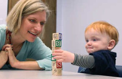 
Study investigator Annette Estes watches as 13-month-old Hugh James plays with a stack of blocks on March 24 in Seattle. Estes and other UW researchers are assessing youngsters to see whether autism may be, for all practical purposes, preventable with intensive early therapy. Associated Press
 (Associated Press / The Spokesman-Review)