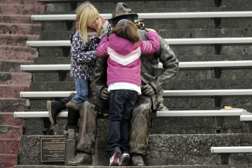 Attention-getter: The Joe Fan statue at Albi Stadium gets a kiss from two  girls attending the Central Valley/Kamiakin 4A play-in football game on Saturday. The statue sits in the lower southwest stands. The Central Valley Bears lost 21-0, ending their season. (Dan Pelle / The Spokesman-Review)