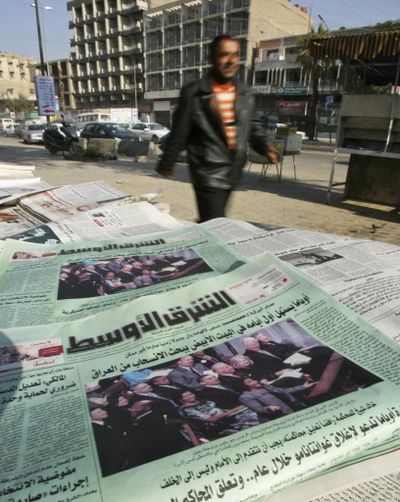 An Iraqi man walks past newspapers featuring front page coverage of U.S. President Barack Obama in Baghdad, Iraq, on Thursday, Jan. 22, 2009. Across this war-shattered country, many Iraqis watched the transfer of power in Washington on Arab satellite television stations. Many of them expressed hope that the departure of the president who launched the Iraq war in 2003 would speed the return of peace.  (Associated Press)