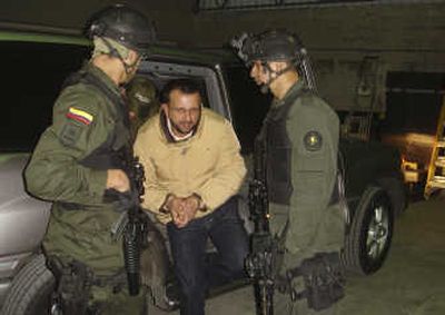 
Former paramilitary leader and accused drug trafficker Carlos Mario Jimenez is escorted by police in Bogota, Colombia, on Wednesday for his extradition to the U.S. Associated Press
 (Associated Press / The Spokesman-Review)