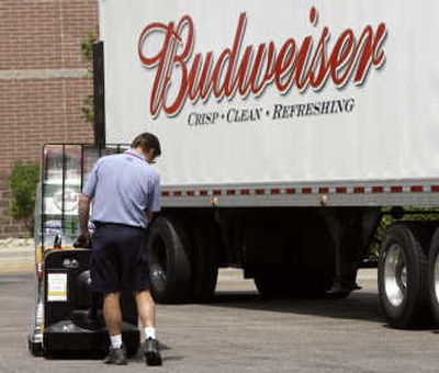 
A delivery man guides a cart loaded with cases of beer off his delivery trailer outside a liquor store in southeast Denver on Wednesday. Anheuser-Busch Cos. reported a 6.1 percent increase in profits during the second quarter.  Associated Press
 (Associated Press / The Spokesman-Review)