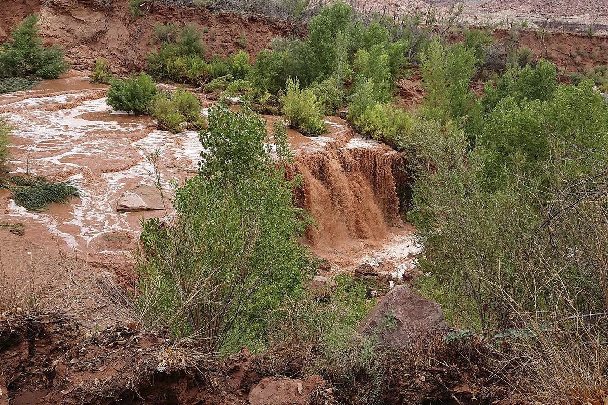 This Thursday, July 12, 2018 photo released by Benji Xie shows flooding from a waterfall on the Havasupai reservation in Supai, Ariz. (Benji Xie / Associated Press)