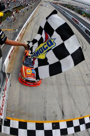 After starting seventh, going down two laps early on and only leading seven laps Aric Almirola takes the checkered flag to win the NASCAR Camping World Truck Series Dover 200 at Dover International Speedway on Friday. (Courtesy: Todd Warshaw/Getty Images) (Todd Warshaw / Getty Images North America)