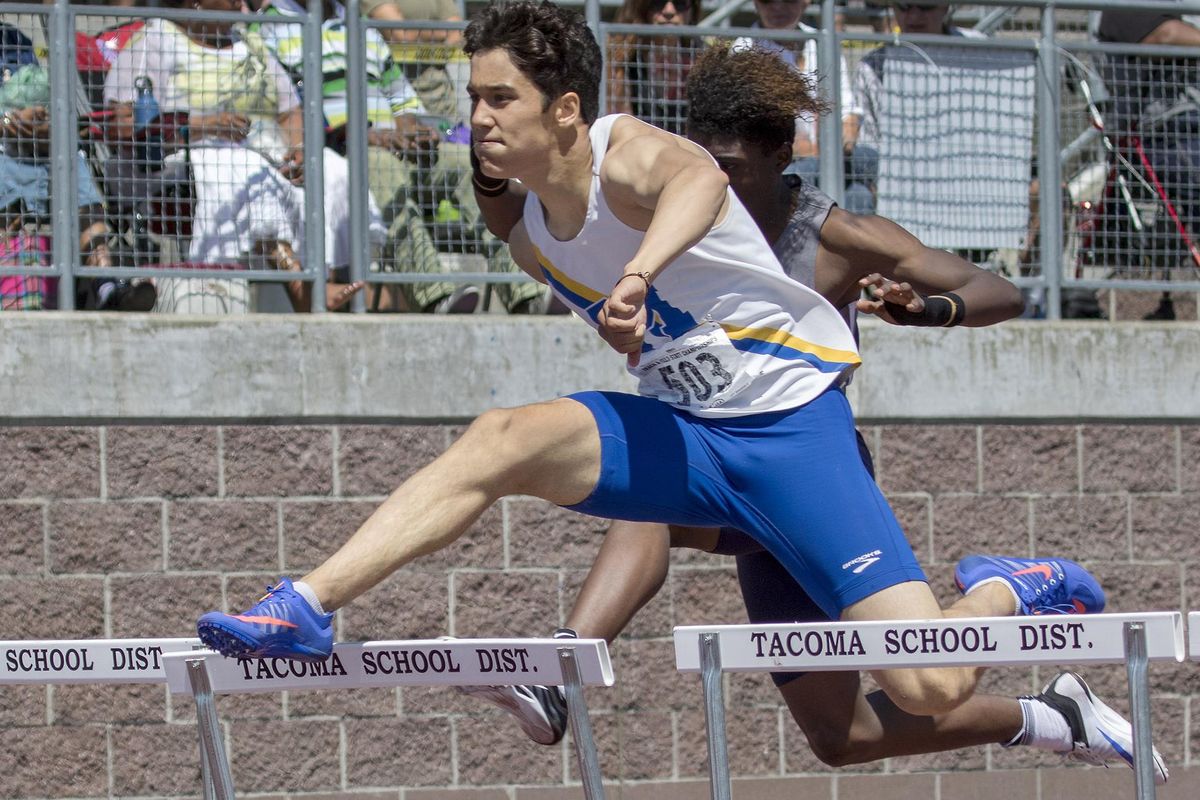 Mead’s Joseph Heitman clears the last hurdle on his way to winning the 4A boys 300-hurdles. He led Mead to the state title. (Patrick Hagerty / For The Spokesman-Review)