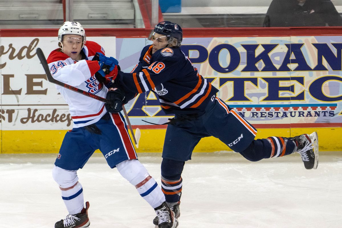 Spokane Chiefs forward Berkly Catton (34) and Kamloops Blazers forward Kobe Verbicky (18) tangle up during the first period of a WHL hockey game, Friday, April, 29, 2022, in the Spokane Veterans Memorial Arena.  (COLIN MULVANY/THE SPOKESMAN-REVIEW)
