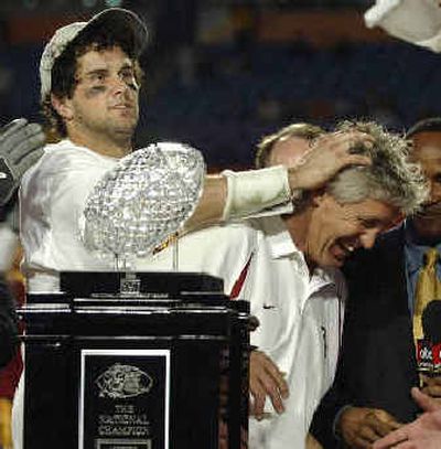 Trojans QB Matt Leinart rubs the head of coach Pete Carroll during the trophy presentation after Tuesday night's Orange Bowl.  
 (Associated Press / The Spokesman-Review)