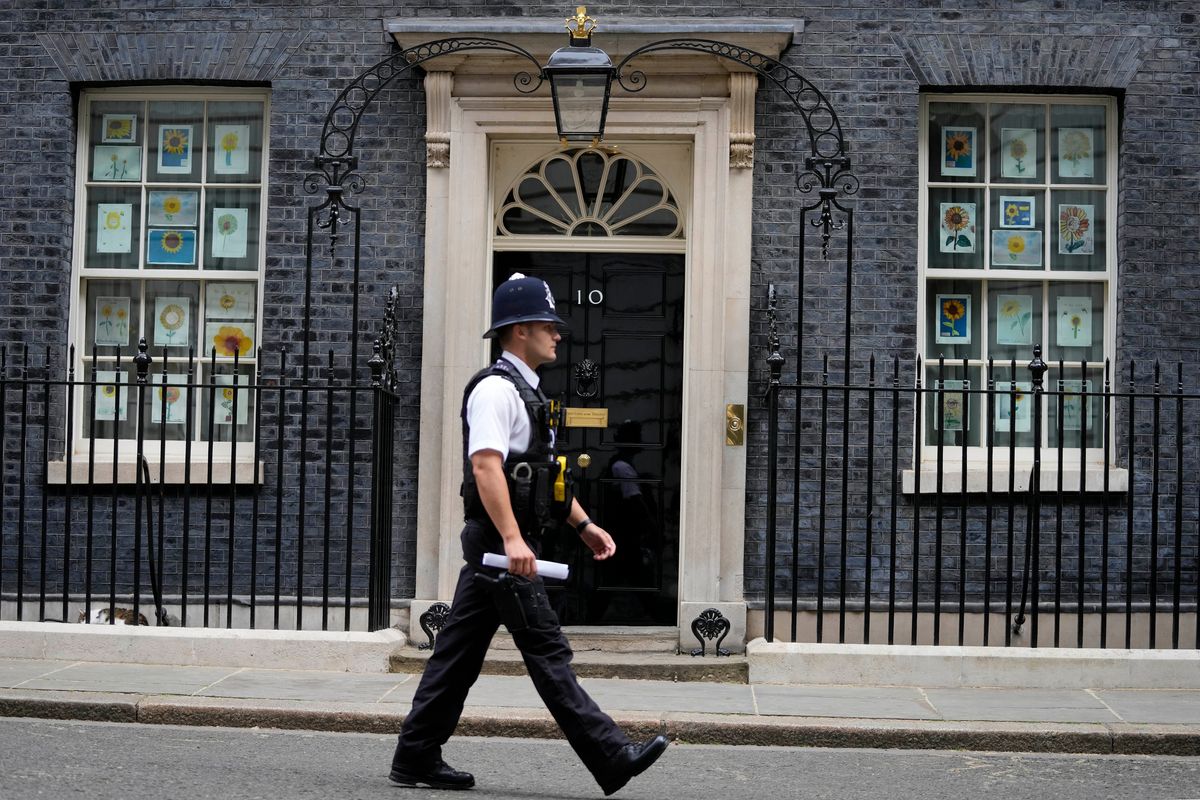 A police officer walks past 10 Downing Street in London on Monday. The general public waits for the release of Sue Gray’s report into COVID lockdown breaches across Whitehall, the so called “Partygate”.  (Frank Augstein)