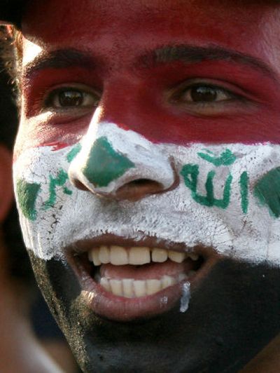 
A young man sports an Iraqi flag and a rare smile on his face as he celebrates in Baghdad after the Iraqi national soccer team defeated Saudi Arabia to win the Asian Cup.  Story, Page A5. Associated Press
 (Associated Press / The Spokesman-Review)