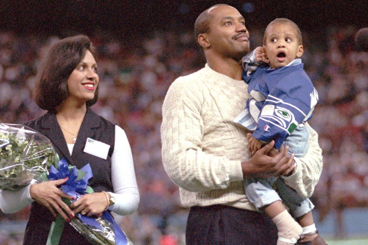 Running back Curt Warner, his wife Ana and 2-year-old son Jonathan take part in a Seahawks’ Ring of Honor ceremony for Warner in November, 1994. In 2008, Jonathan was credited with saving family members’ lives from a house fire that was started by one of his younger autistic brothers. (BARRY SWEET / Associated Press)