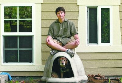 Nate Robnett-Conover, a new graduate of Lewis and Clark High School, relaxes with his dog, Buster. 
 (Dan Pelle / The Spokesman-Review)