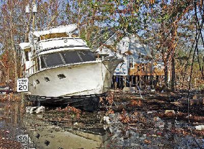 
A boat sits in the front yard of a home last week in Gulfport, Miss. While a nation debates what happened across the lake in New Orleans and trucks haul entire neighborhoods to the dump in Mississippi, thousands are mourning the loss of a quieter side of life on the coast. The region's fishing, boating and hunting industries were wiped out by the storm, and no one is sure when they will recover. 
 (Associated Press / The Spokesman-Review)
