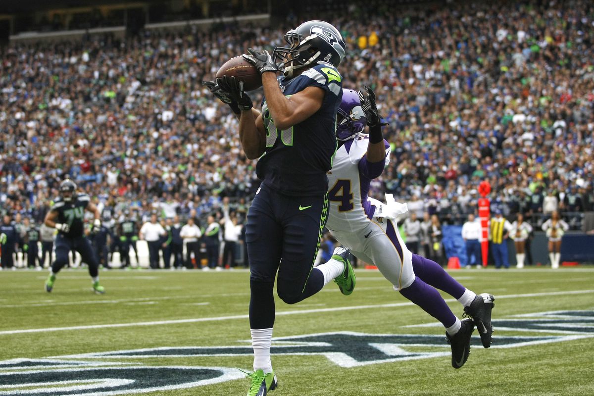 Seahawks receiver Golden Tate catches a pass for a touchdown against the Vikings, one of six for Tate so far this season. (Associated Press)